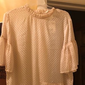 Cream colored semi sheer ruffled sleeve top